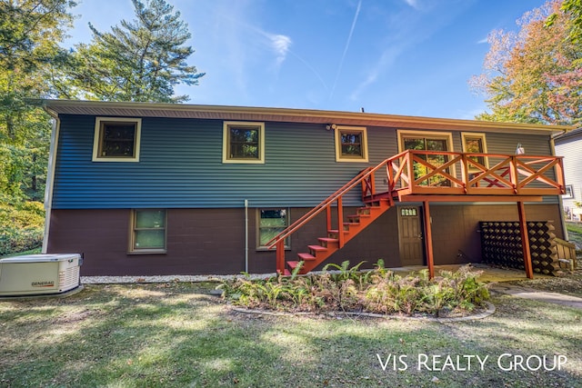 back of property with stairs and a deck