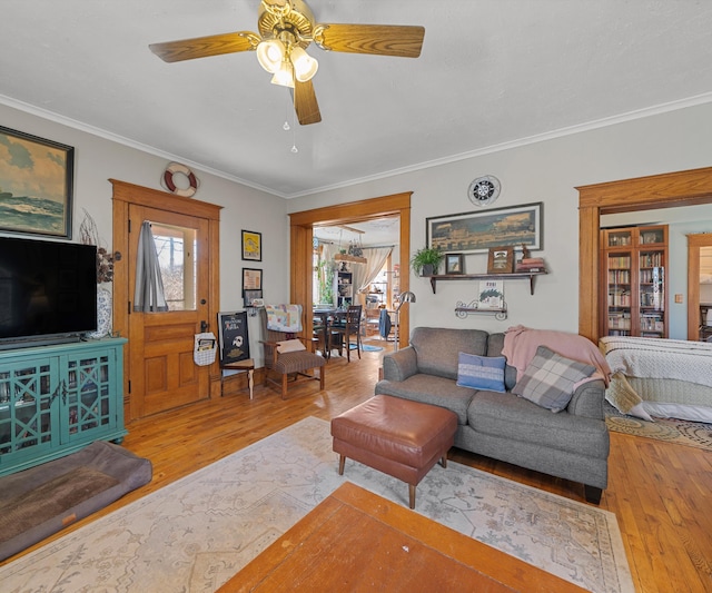 living room featuring crown molding, ceiling fan, and wood finished floors