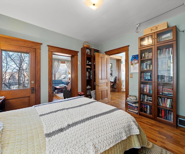 bedroom with wood finished floors and visible vents