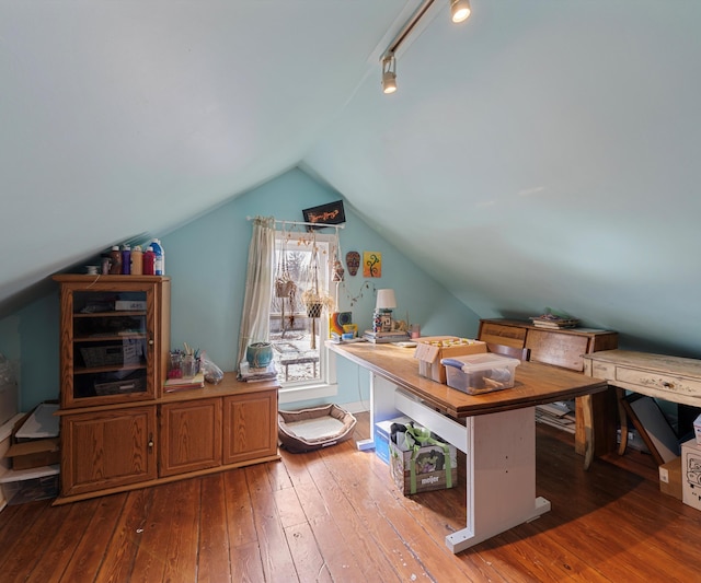 office with wood-type flooring, track lighting, and vaulted ceiling