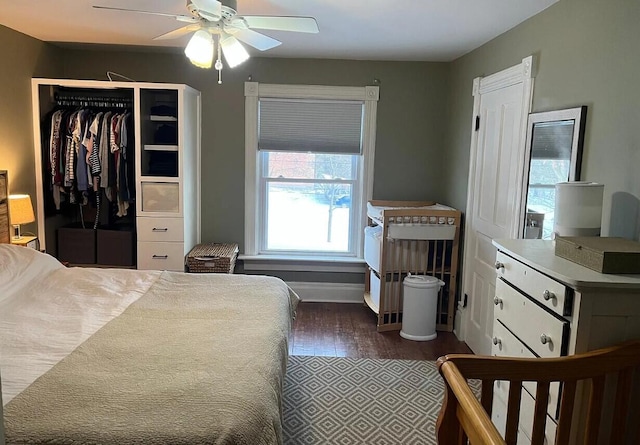 bedroom featuring baseboards, dark wood-type flooring, and ceiling fan