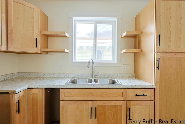 kitchen with open shelves, light brown cabinets, and a sink