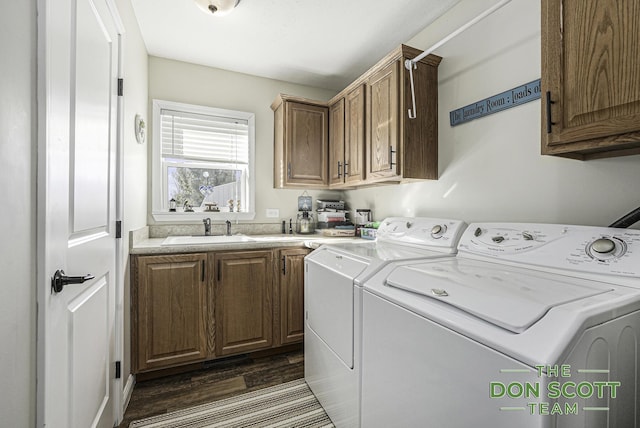 laundry area with washer and clothes dryer, dark wood-style floors, cabinet space, and a sink