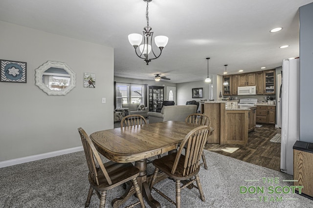 dining space with recessed lighting, baseboards, dark wood-style flooring, and ceiling fan with notable chandelier