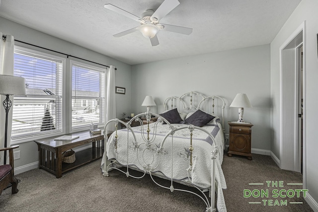 carpeted bedroom with a ceiling fan, baseboards, and a textured ceiling