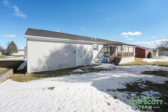 back of property with a pergola and a deck