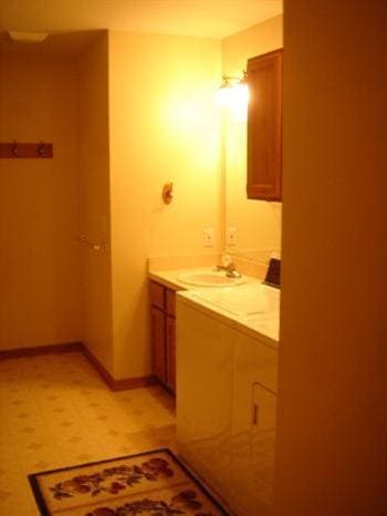 bathroom with vanity and baseboards