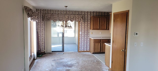 unfurnished dining area with unfinished concrete flooring