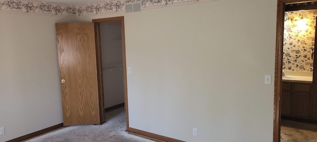 spare room featuring visible vents and baseboards