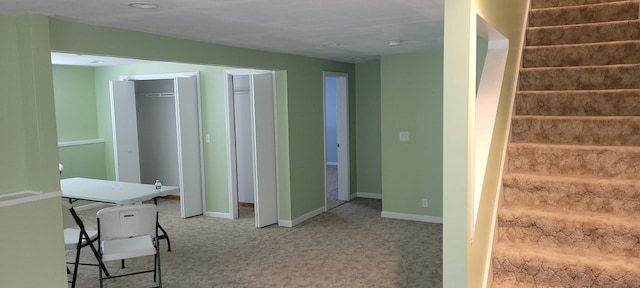 interior space featuring carpet flooring and baseboards