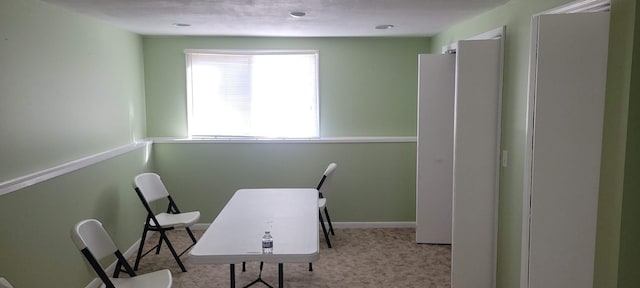 carpeted home office with baseboards