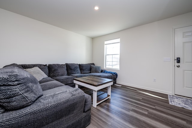 living area featuring baseboards and wood finished floors