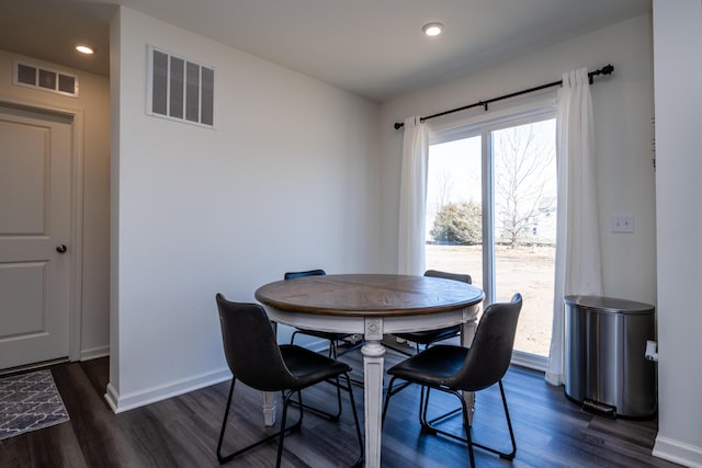 dining space featuring dark wood finished floors, visible vents, and baseboards