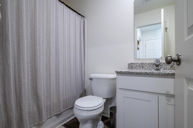 full bath with visible vents, toilet, wood finished floors, shower / bath combination with curtain, and vanity