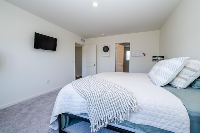 carpeted bedroom with visible vents and baseboards