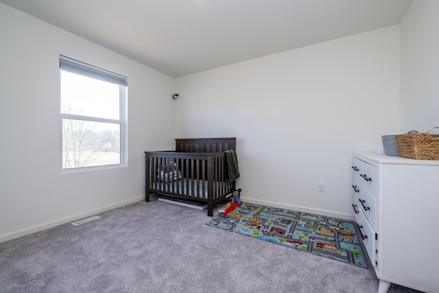 carpeted bedroom with visible vents and baseboards