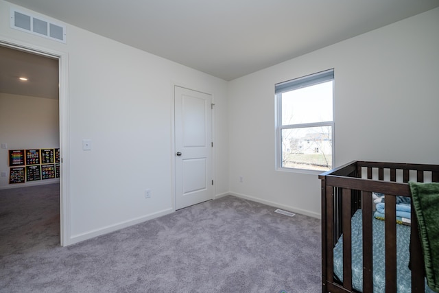 unfurnished bedroom featuring carpet, visible vents, and baseboards