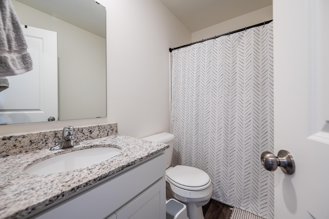 bathroom with vanity, a shower with shower curtain, and toilet