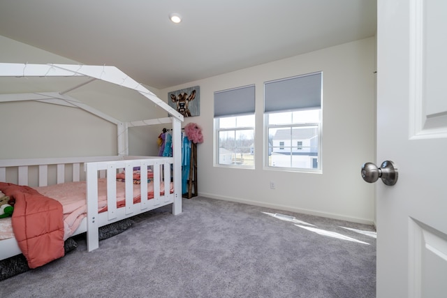 bedroom featuring carpet and baseboards