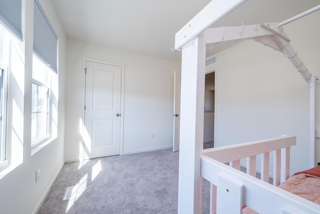 unfurnished bedroom with visible vents, baseboards, and carpet floors