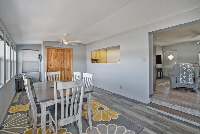 dining area with a ceiling fan and wood finished floors