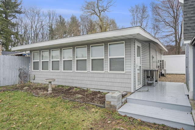 view of home's exterior featuring fence and a deck