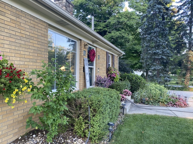 doorway to property featuring brick siding