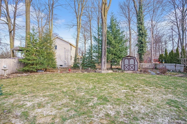 view of yard featuring a storage shed, an outdoor structure, and fence