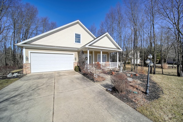 view of front facade featuring stone siding, an attached garage, covered porch, and driveway