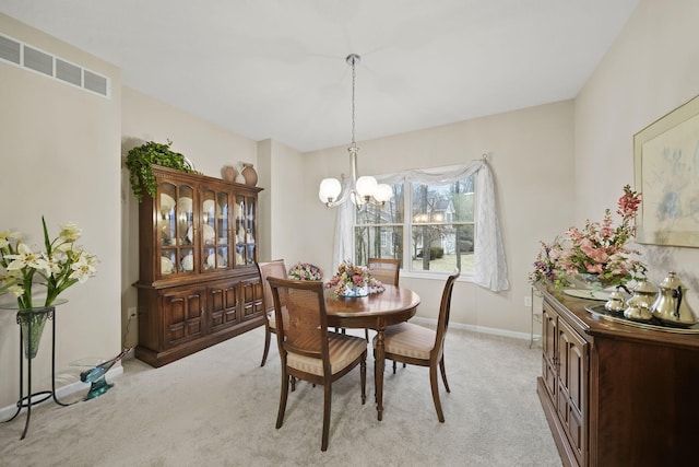 dining space featuring an inviting chandelier, baseboards, visible vents, and light carpet