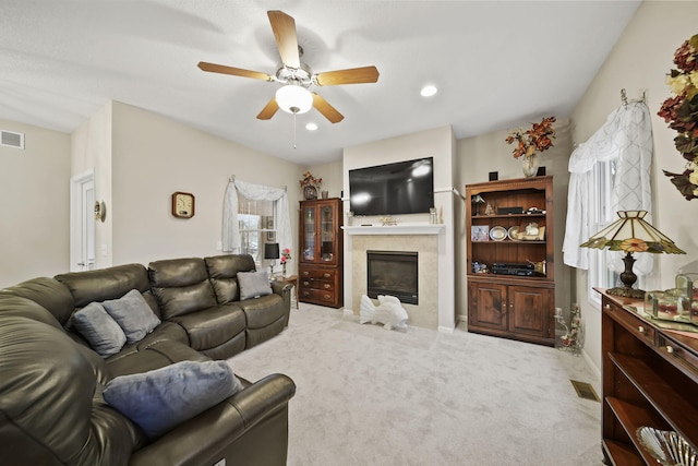 living room featuring visible vents, carpet floors, and a fireplace