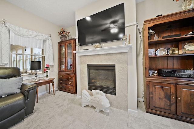 living area featuring baseboards, carpet, and a fireplace