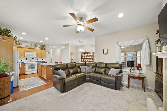 living room featuring recessed lighting, baseboards, and a ceiling fan