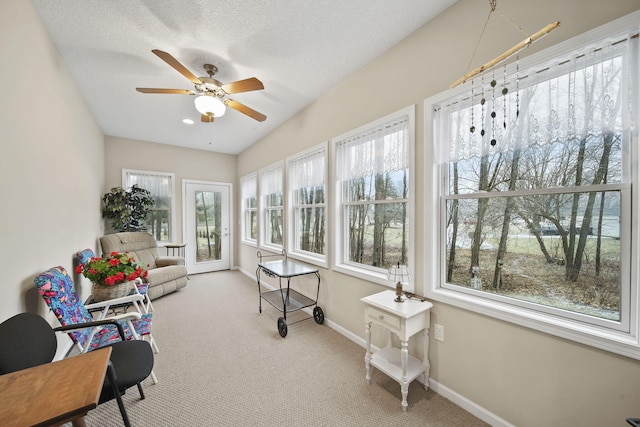 sunroom / solarium featuring a ceiling fan