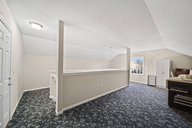 bonus room featuring baseboards, carpet floors, and vaulted ceiling