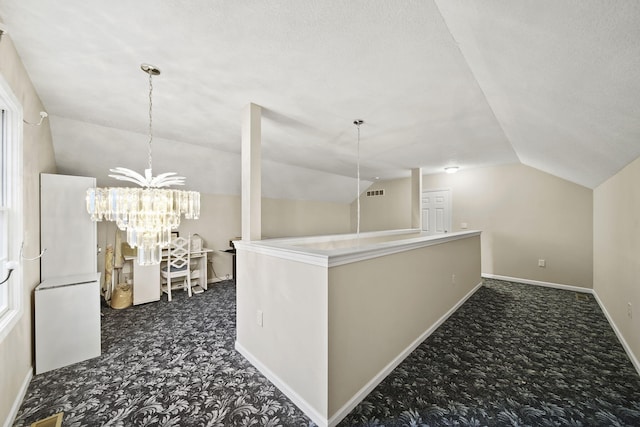 corridor featuring lofted ceiling, baseboards, dark carpet, and a chandelier