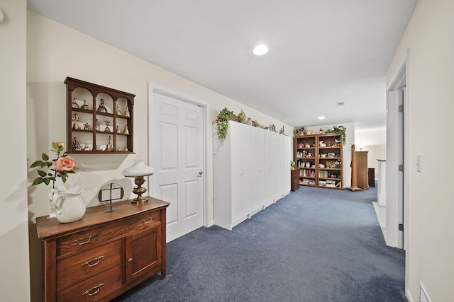 hall with recessed lighting and dark colored carpet