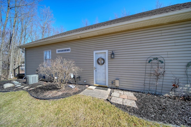 exterior space featuring a lawn and central AC unit