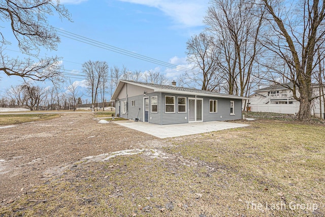 back of house with a patio, a lawn, driveway, and fence