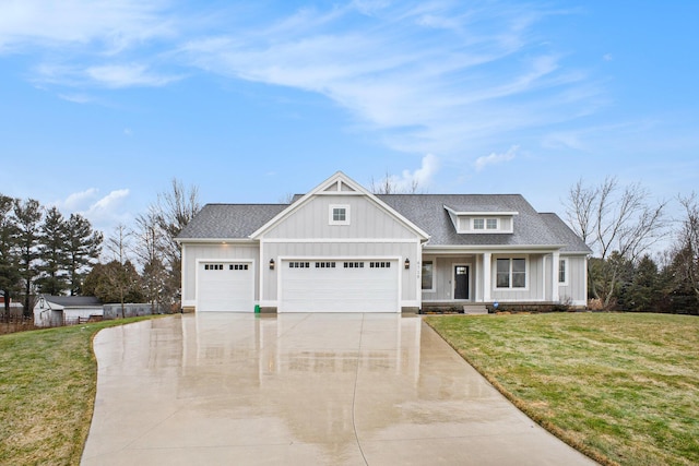 view of front of house featuring driveway, roof with shingles, board and batten siding, a front yard, and a garage