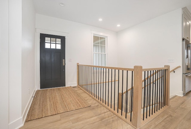 entrance foyer with recessed lighting, baseboards, and light wood-style flooring