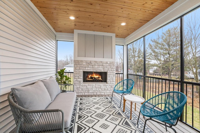 sunroom / solarium with wood ceiling and an outdoor brick fireplace