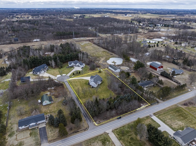 birds eye view of property with a rural view