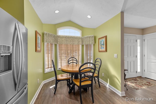 dining area featuring baseboards, lofted ceiling, recessed lighting, wood finished floors, and a textured ceiling