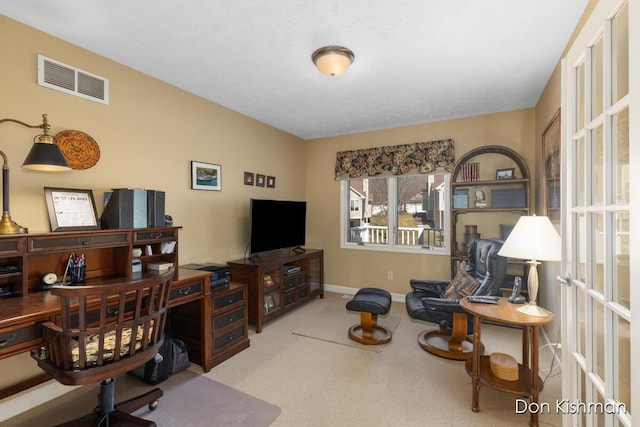 office space with visible vents, baseboards, and carpet floors