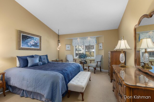 bedroom with baseboards, lofted ceiling, and light carpet