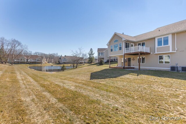 view of yard featuring a residential view, a water view, central AC unit, and a patio