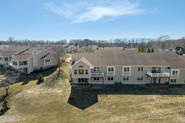 rear view of house with a yard and a residential view