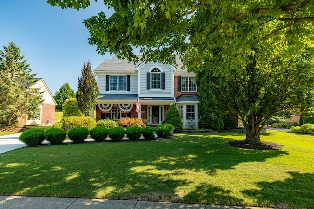 view of front of property with brick siding and a front yard