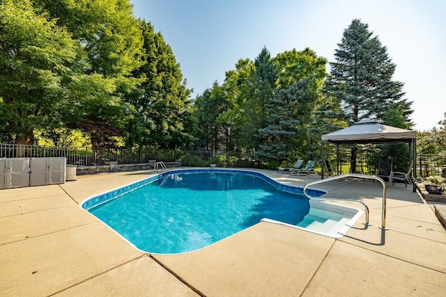 view of swimming pool featuring a gazebo, a fenced in pool, a patio, and fence